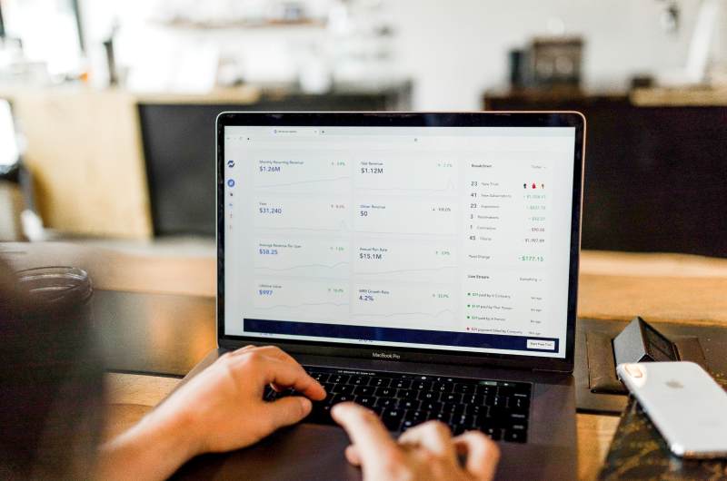 Person working on a laptop with an analytics dashboard