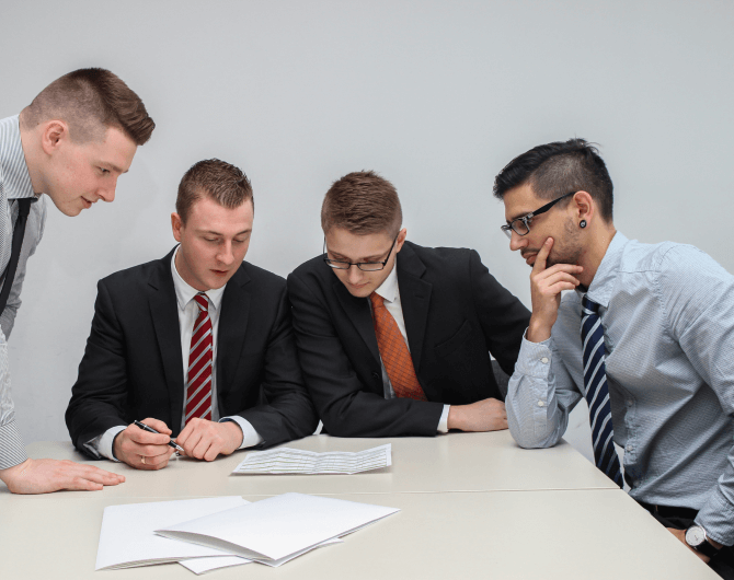 Team of professionals reviewing documents together at a meeting table